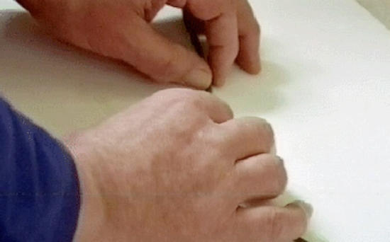 Image of a thin strip of plasticine being placed on canvas